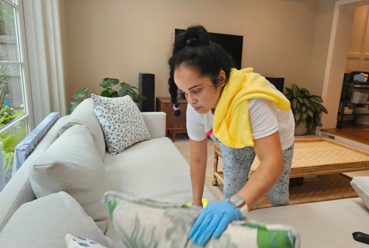 Professional house cleaner wiping down a in a modern Silver Spring home