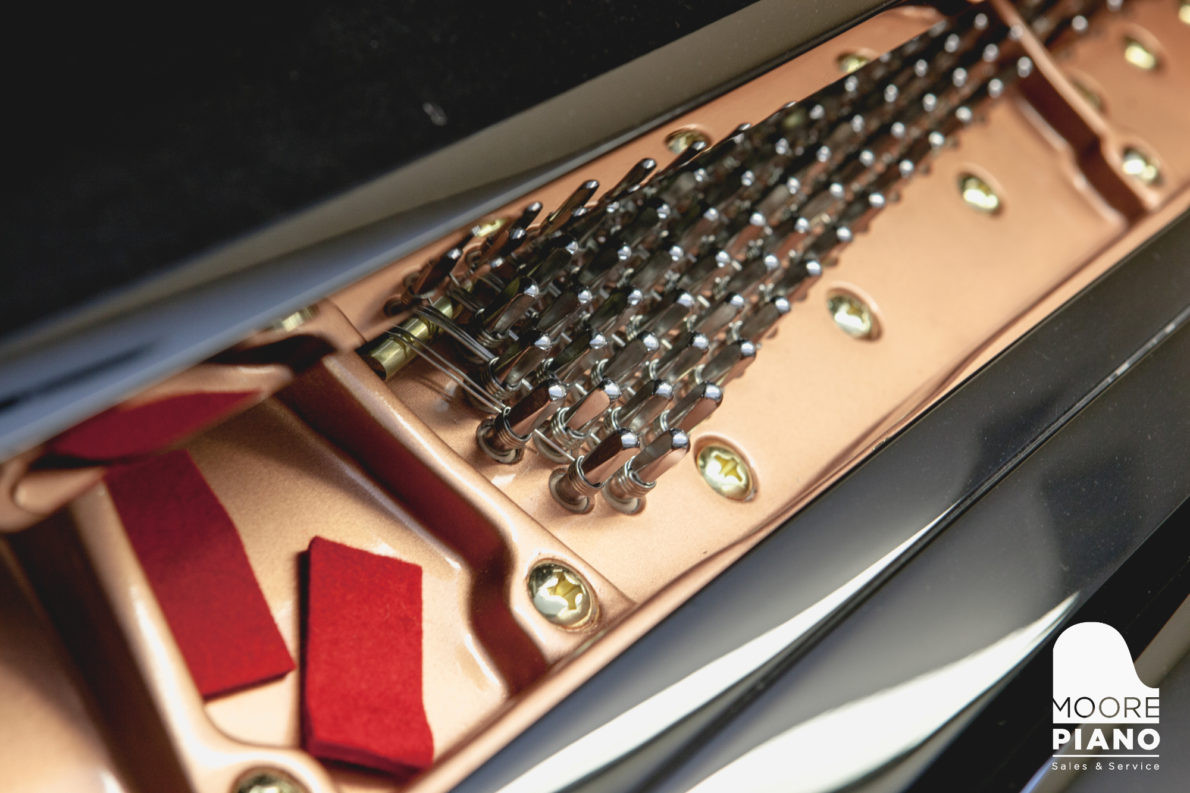 Upright piano being tuned in a home to prevent seasonal pitch drift