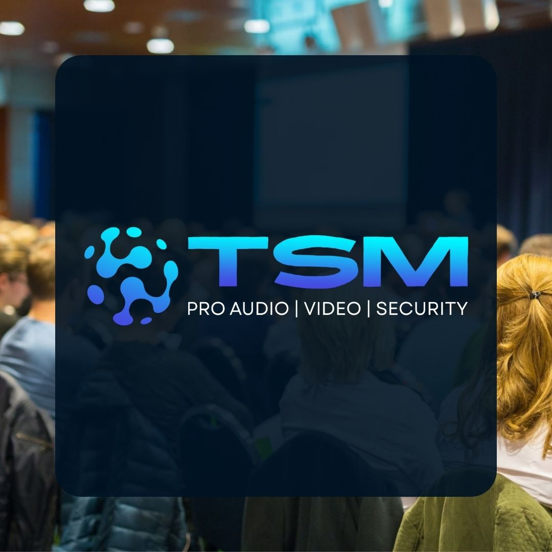 TSM Pro Audio Video Security logo over a blurred conference background