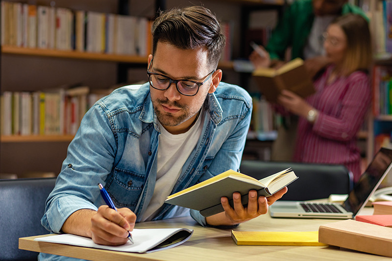 A teacher studying, completing an online continuing education course through DominicanCaOnline.