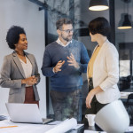 mentor-is-standing-office-explaining-mentees-things-about-project-min.jpg