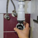 plumber fixing clogged pipe.jpg