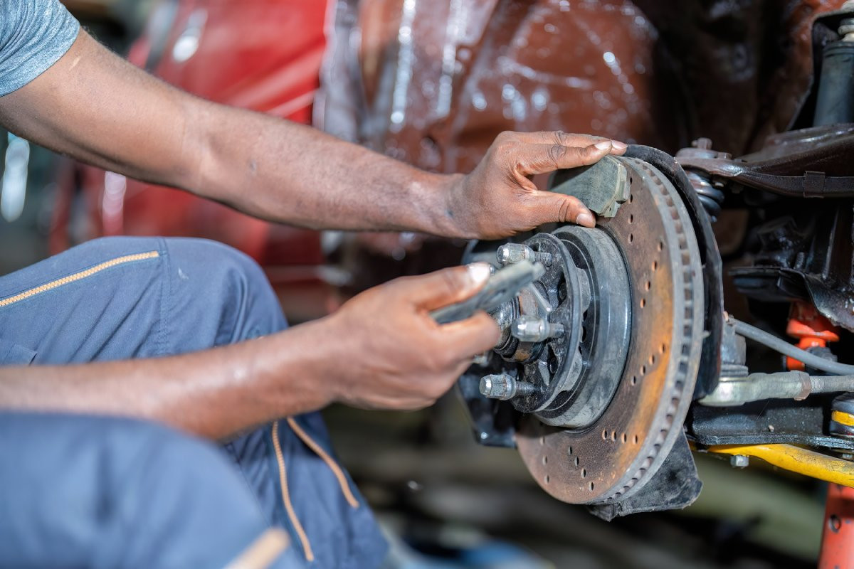 mechanic repairing brakes