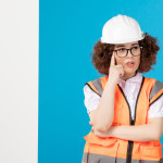 front-view-thinking-female-builder-uniform-blue-wall-min.jpg