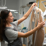 laundry-office-worker-holding-hanger-with-coat-in-2023-11-27-05-21-46-utc-1280x854.jpg