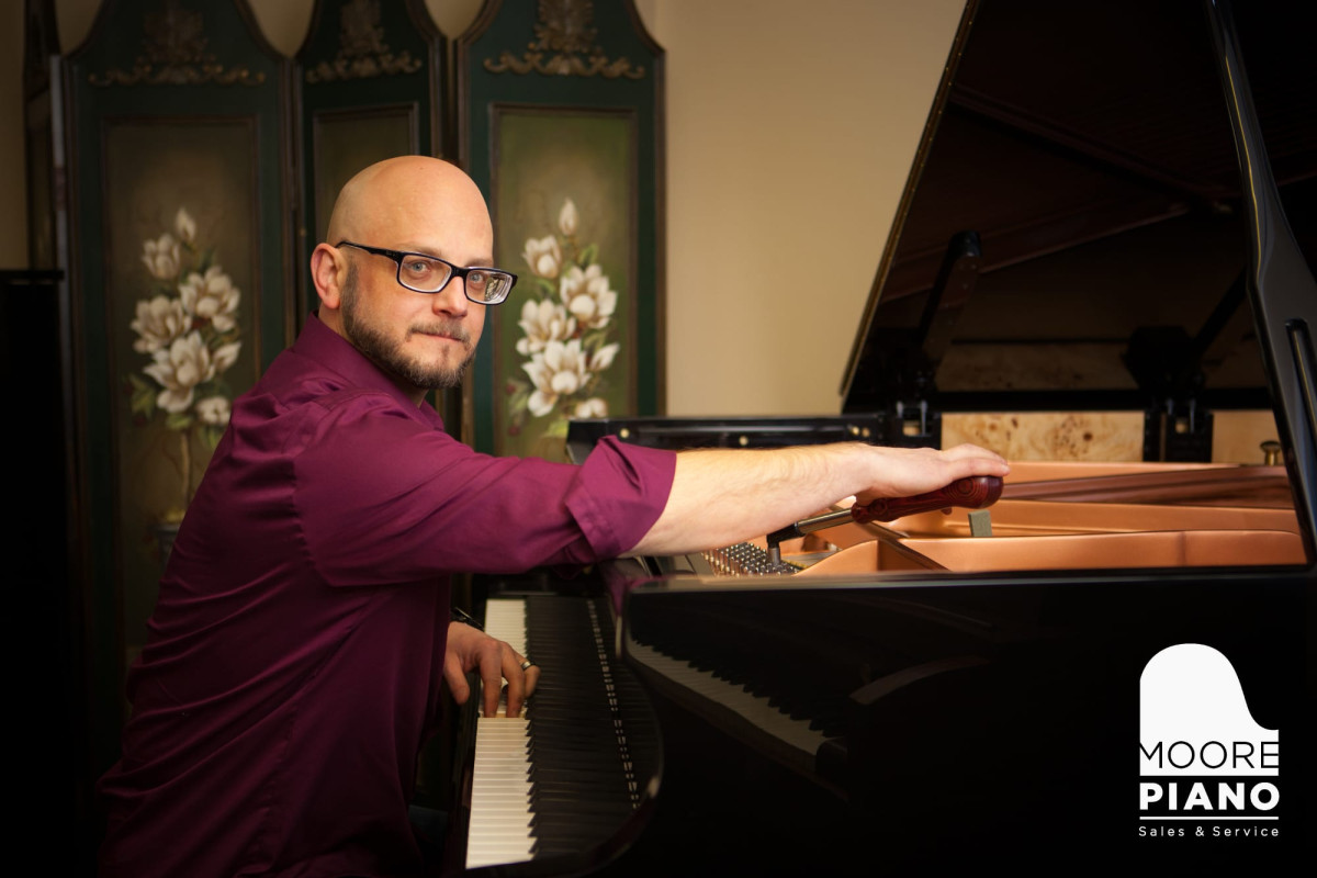 iano tuner adjusting the strings of a grand piano to support student learning and performance
