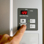 finger_on_hot_water_heater_control_unit_Roto-Rooter_St_George_Utah.jpg