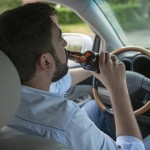 man drinks a beer while driving.jpg