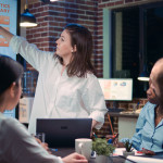 employee-speaking-business-meeting-presentation-holding-laptop-financial-analytics-report-team-working-company-research-statistics-planning-marketing-strategy-discussing-charts-min.jpg