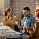 team-young-entrepreneurs-having-business-meeting-office-focus-is-businessman-using-digital-tablet-min.jpg