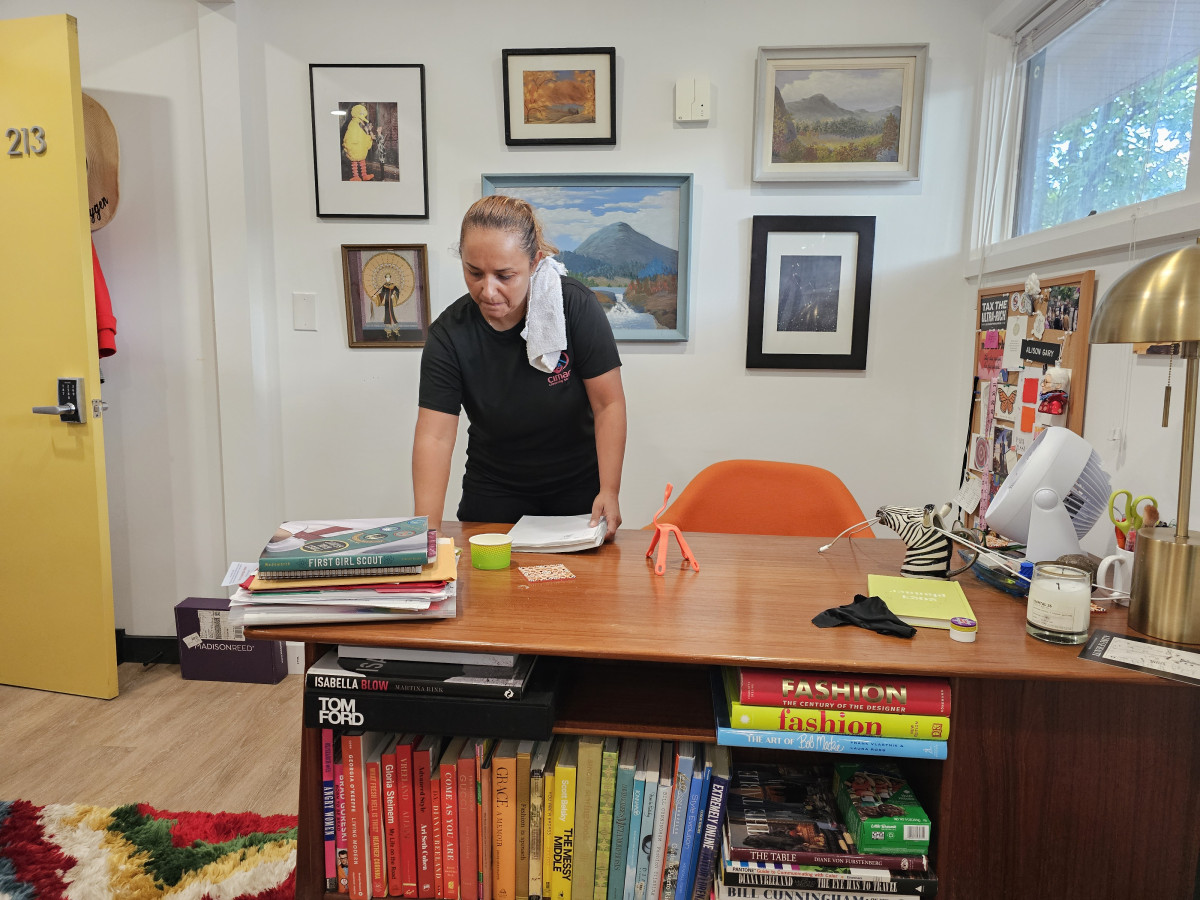 Office cleaner tidying a bright, modern workspace in a Silver Spring business