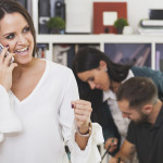 cheerful-woman-talking-phone-celebrating-min.jpg