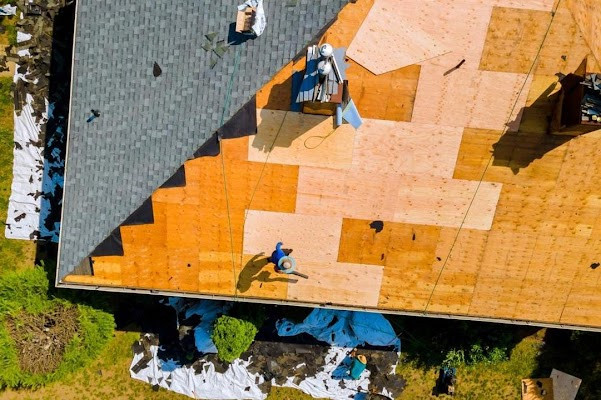 Roofers repairing roof due to storm damage