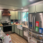 remodeled kitchen with painted cabinets, bronze oven hood, custom cabinetry and custom kitchen island.JPG