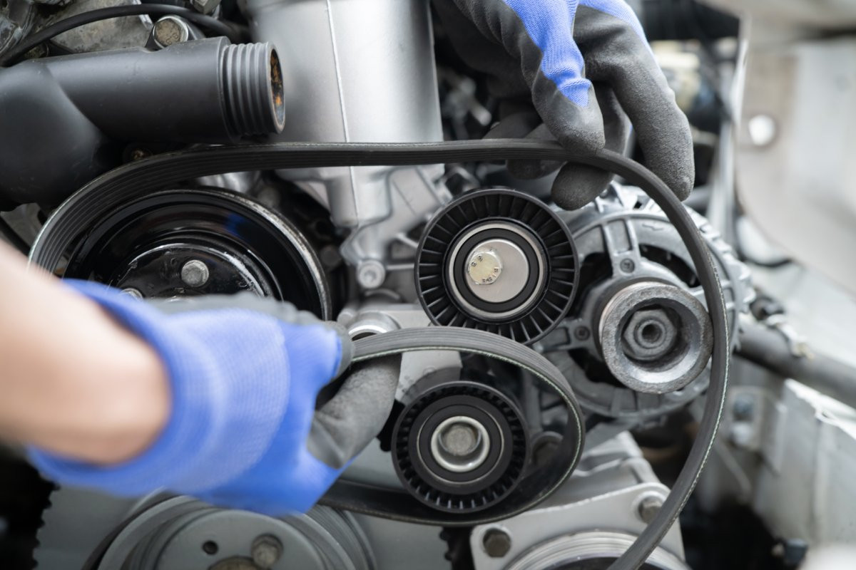 mechanic repairing car timing belt